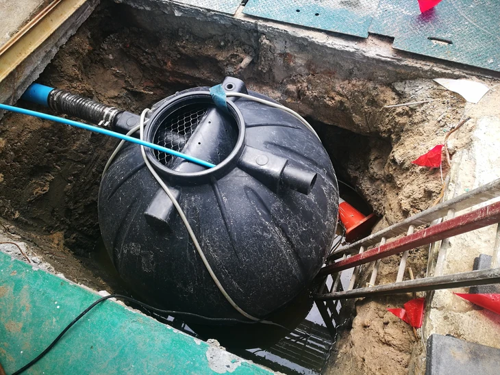 Scène extérieure sur pelouse verte avec équipements de piscine disposés sur chaise blanche en plastique et structure bois